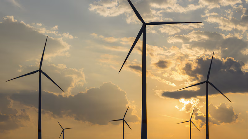wind turbines in a cloudy evening sky